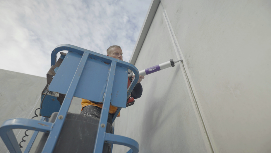 Contractor applying SabreSeal FRM to tilt panel joint on EWP