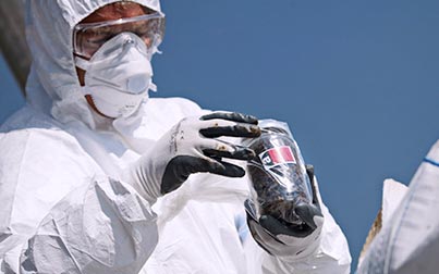 Sabre chemist with protection white clothes with a closed jar in his hand
